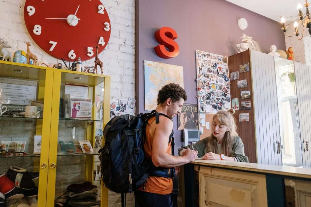 Backpacker speaking with the receptionist in one of the Ideal Youth Hostels in Barcelona