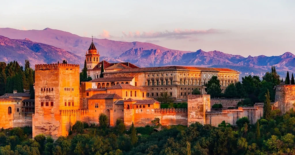 The breath-taking Alhambra Palace in Granada with the Sierra Nevada mountains in the background. Granada stands out as one of the best cities in Spain for history lovers.