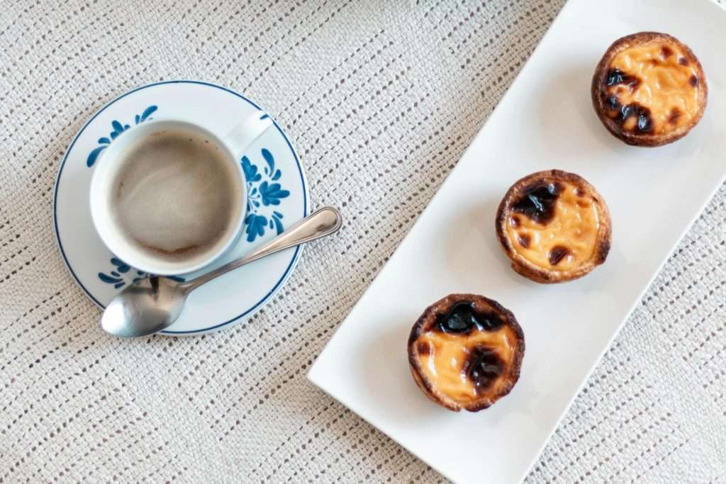 What to do in Lisbon? Savor a delicious Pastel de Nata, Lisbon’s famous custard tart, best enjoyed with a Portuguese espresso at a traditional café.
