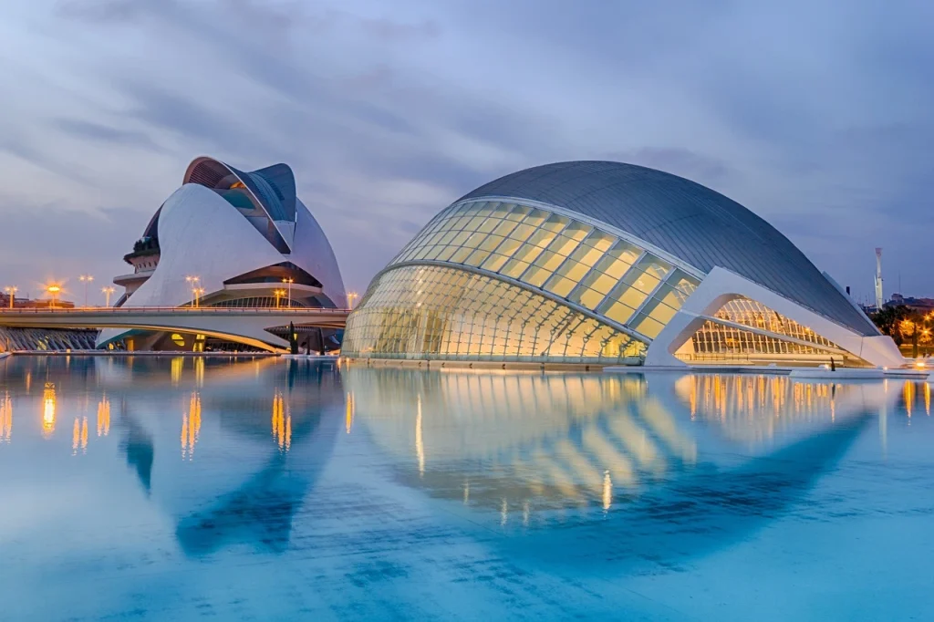 The futuristic City of Arts and Sciences in Valencia, reflecting in the water at dusk. Valencia is among the best cities in Spain for culture and modern design.