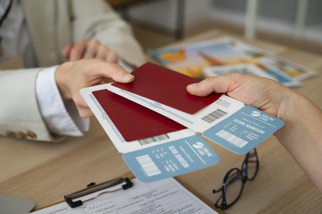Traveller handing over passport and flight ticket at a desk, preparing paperwork for a Singapore Work Visa application process.