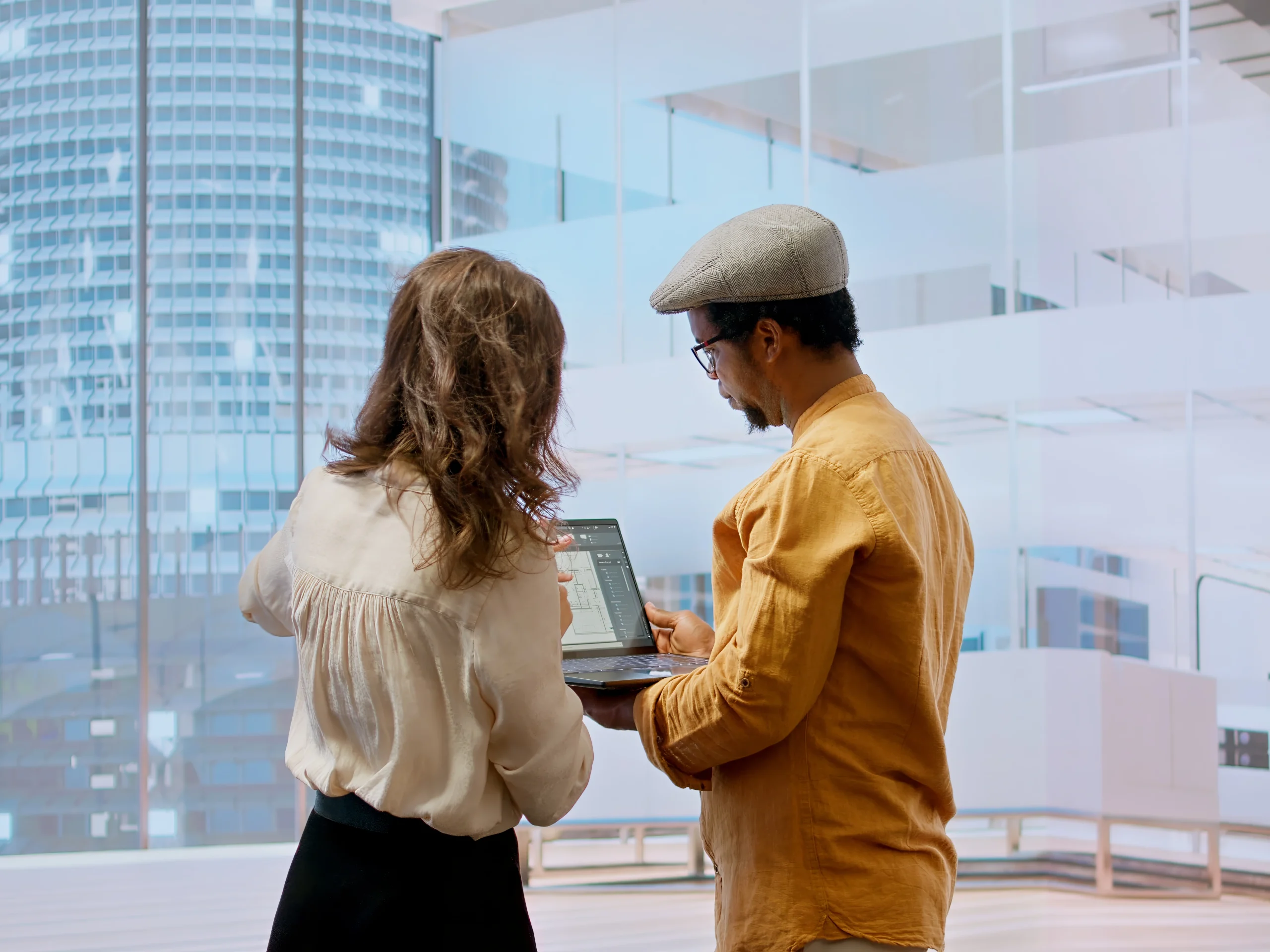 Professionals discussing job opportunities in an office setting, reviewing documents needed for a Singapore Work Visa application.