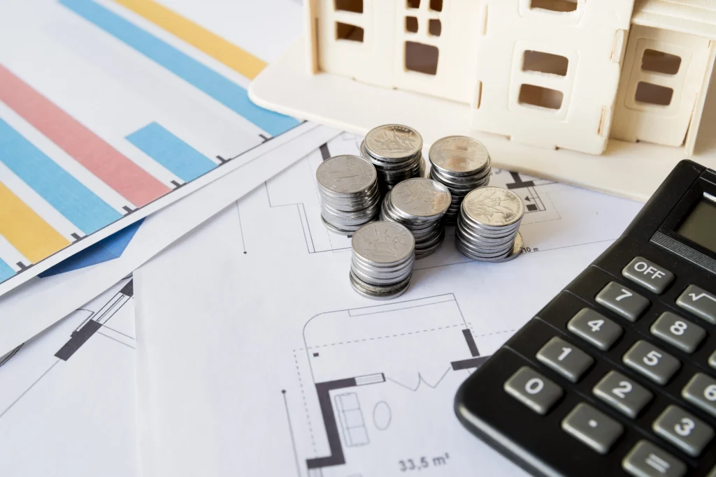 Financial planning documents and savings related to Unemployment in Italy, showing coins, a calculator, and housing charts.