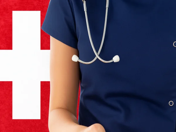 Healthcare in Switzerland represented by a doctor’s torso with a stethoscope in front of the Swiss national flag.