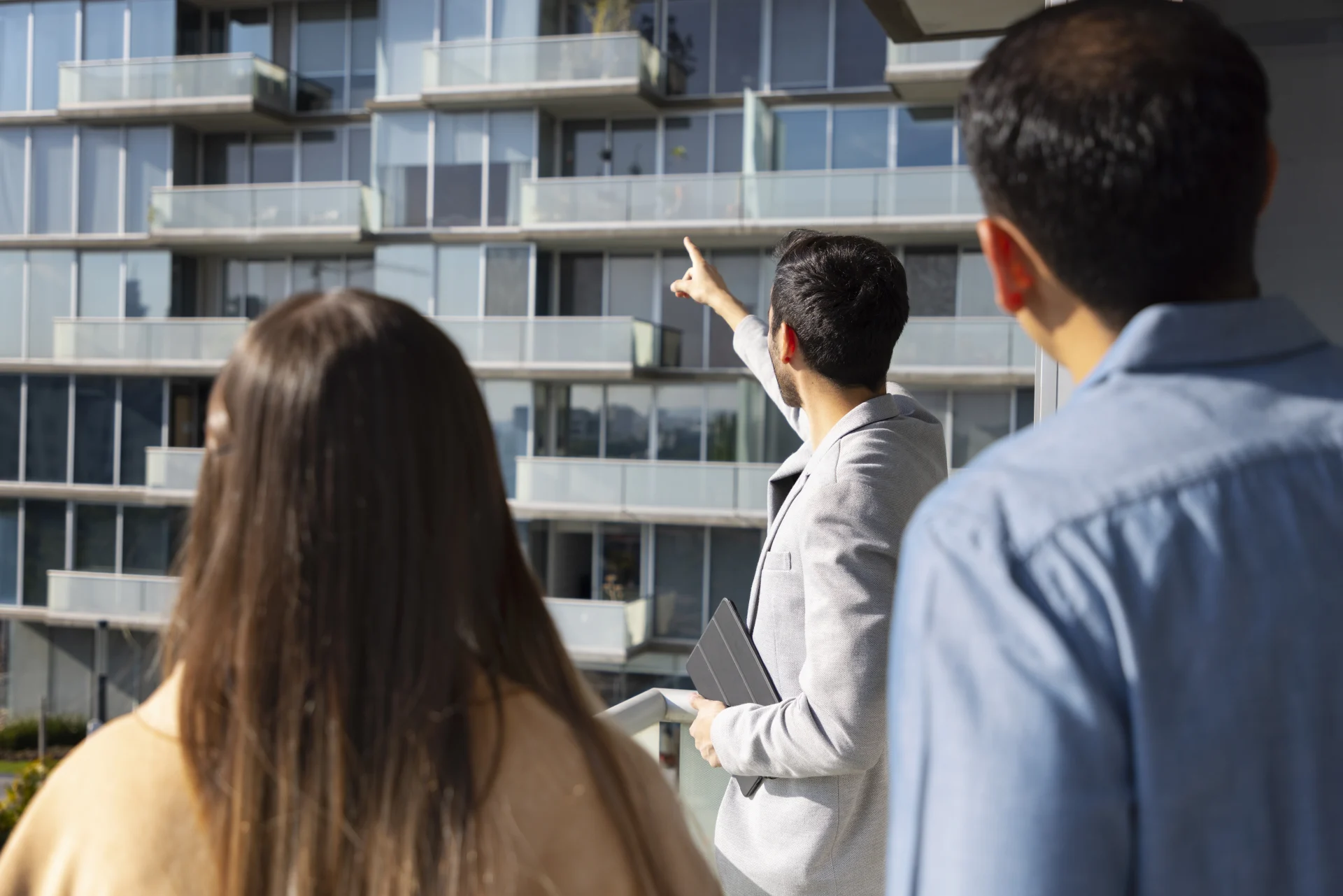 Expats visiting a modern flat with a real estate agent during the housing in Switzerland search process.