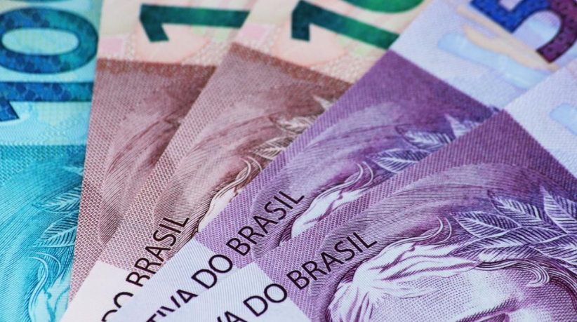 Detailed close-up of colorful Brazilian real banknotes, highlighting currency design, textures, and denominations in purple, blue, and green