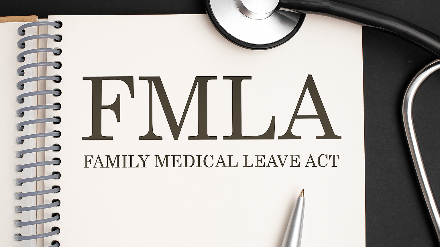 Carnet avec l’inscription FMLA et un stéthoscope, représentant le Family Medical Leave Act et les droits sociaux au travail aux États-Unis.