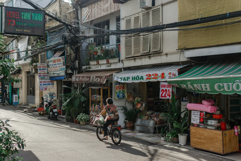 Small grocery shops and local eateries in a residential Saigon alley, Vietnam