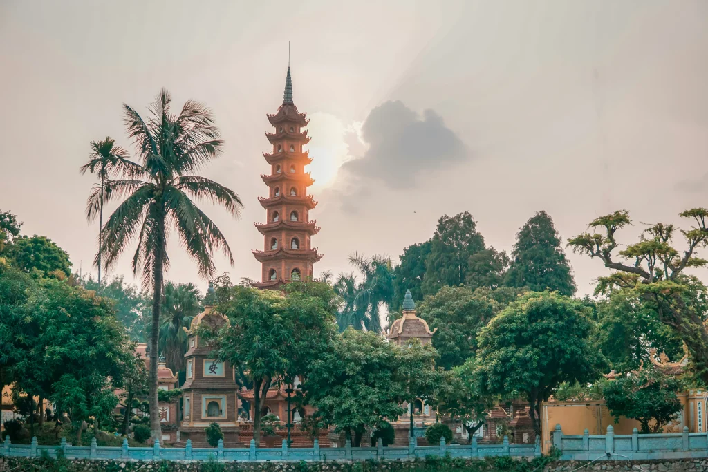 Tran Quoc Pagoda surrounded by tropical trees in Hanoi, Vietnam