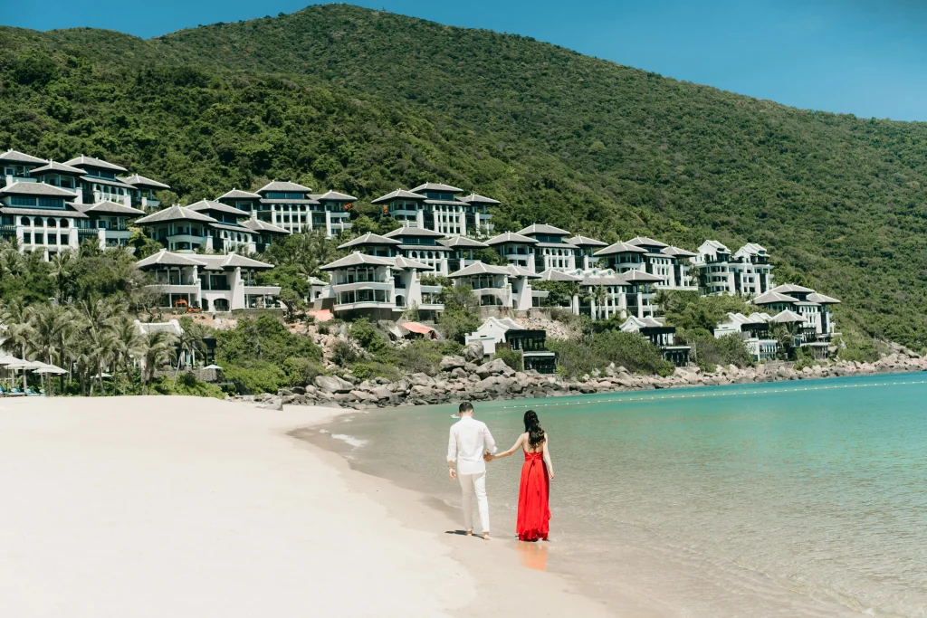 Couple walking on beach near luxury resorts in Da Nang, Vietnam