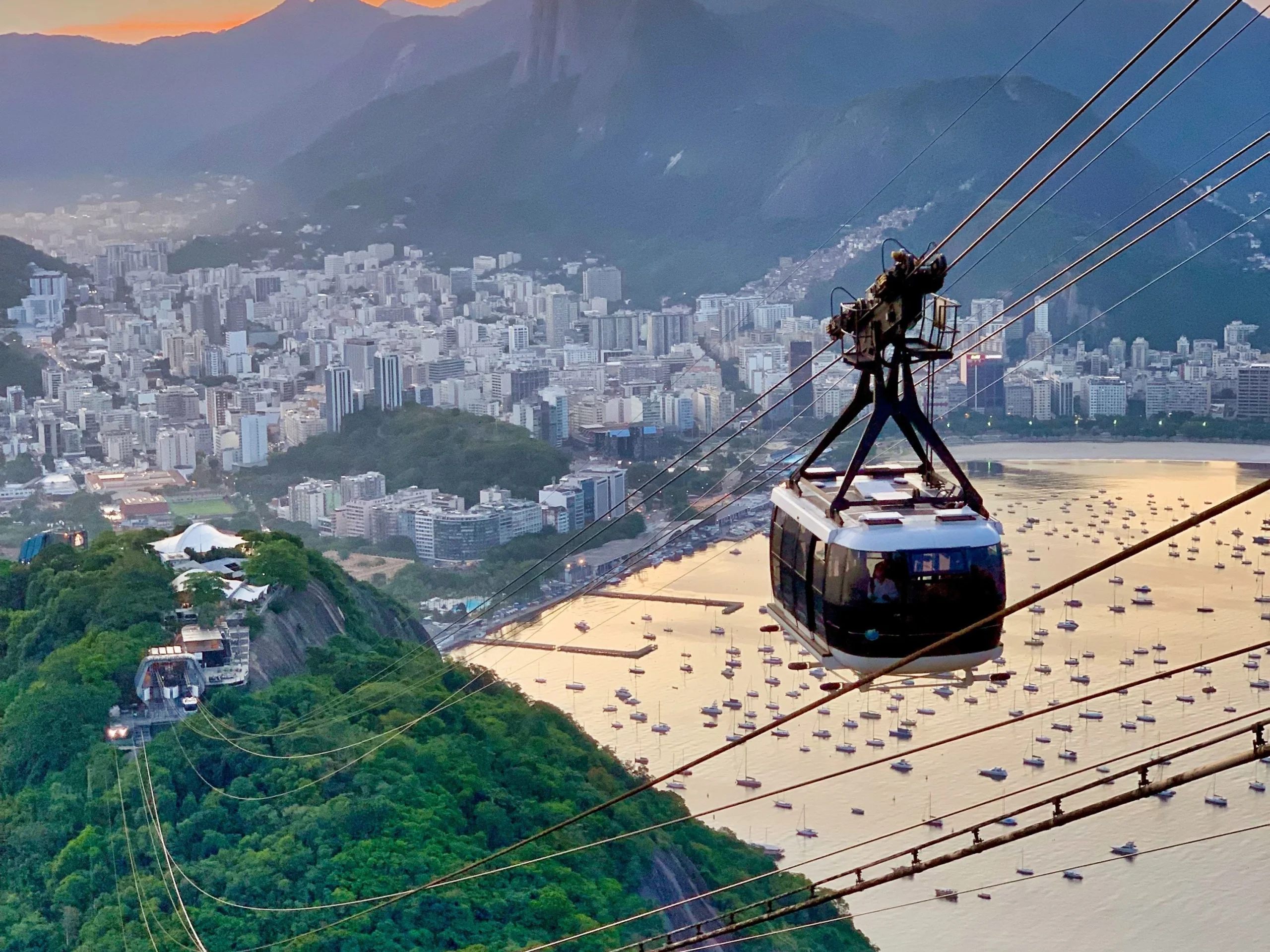 Sugarloaf Cable Car in Rio de Janeiro with views of Christ the Redeemer at sunset.