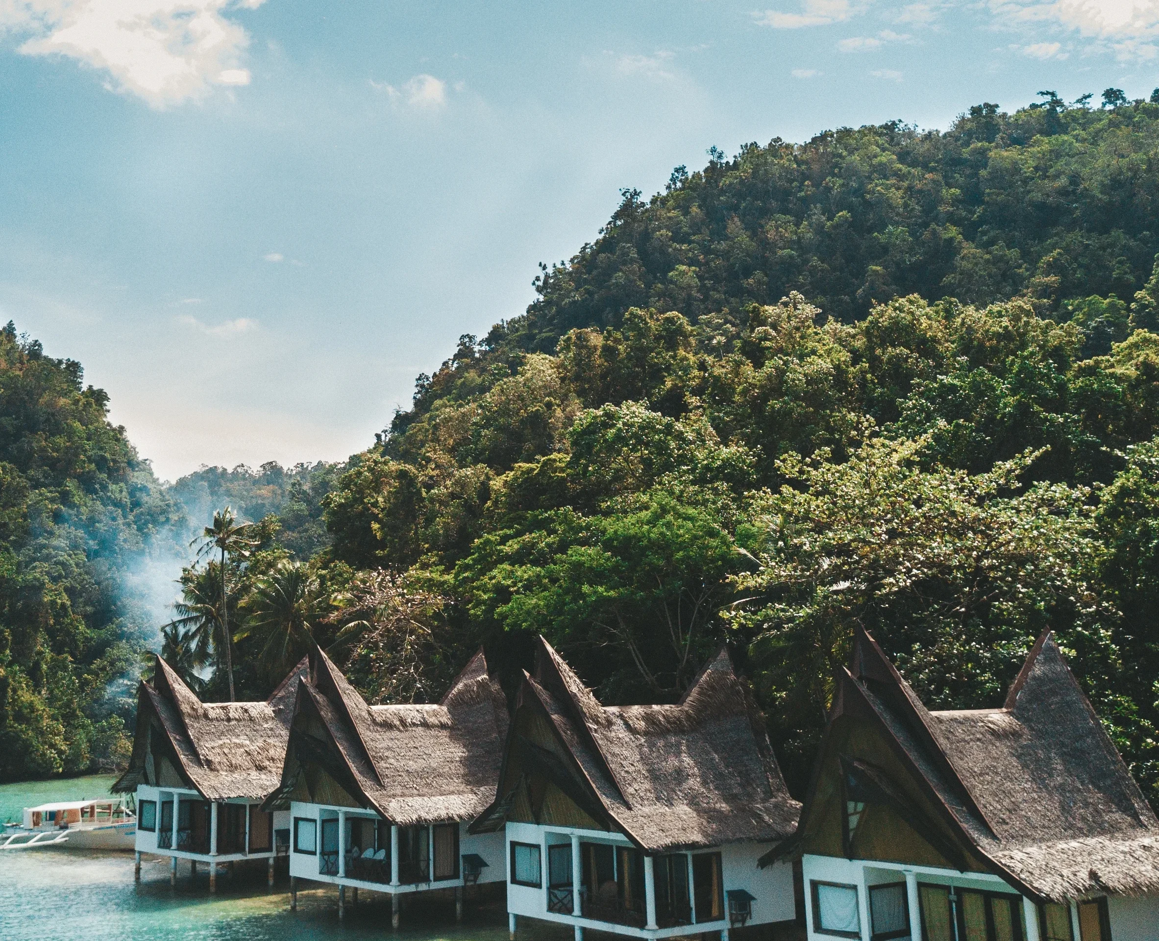 Housing in Indonesia, overwater bungalows in a tropical lagoon.