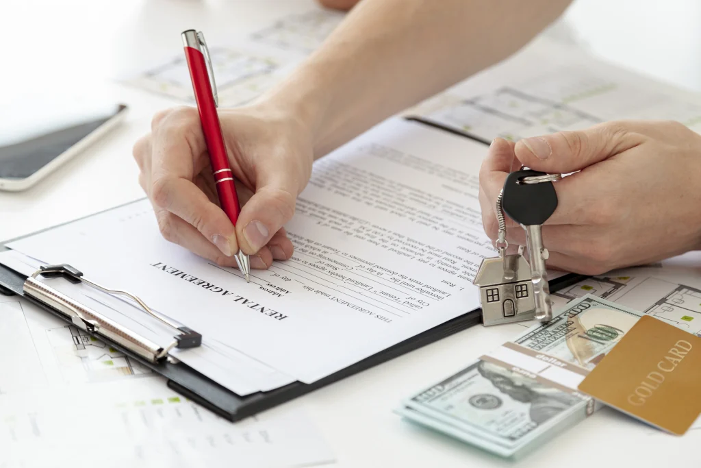 Signing a rental contract for student housing in Vietnam, with keys and rental documents.